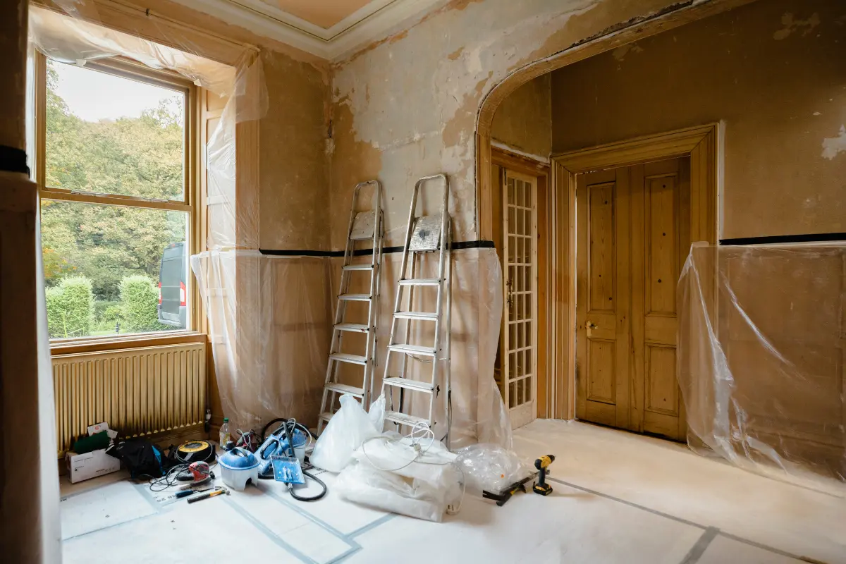 Residential room under renovation with ladders, tools, and materials, ideal for residential on-site storage containers